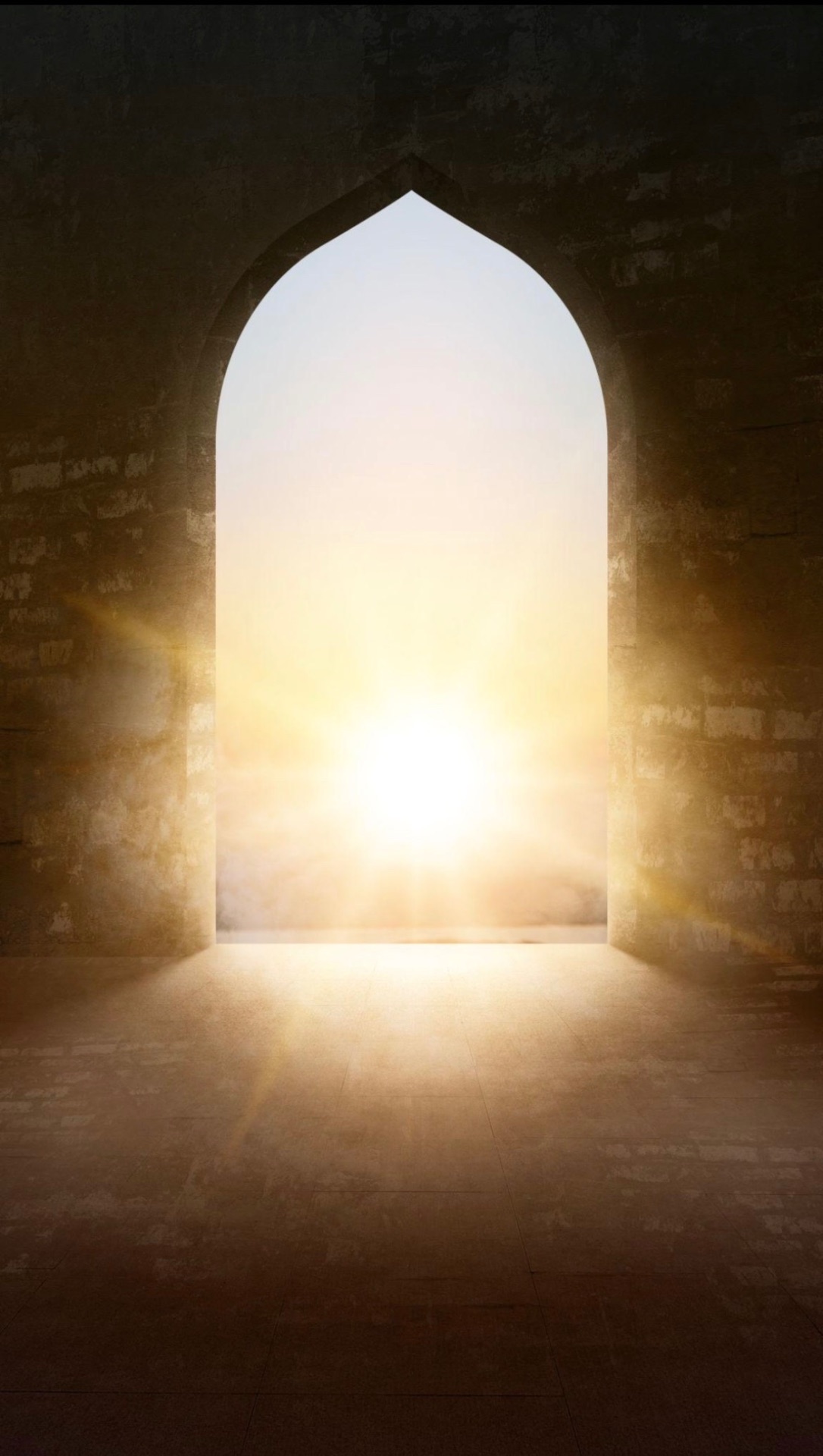 Light breaking through a stone pointed arch at dawn
